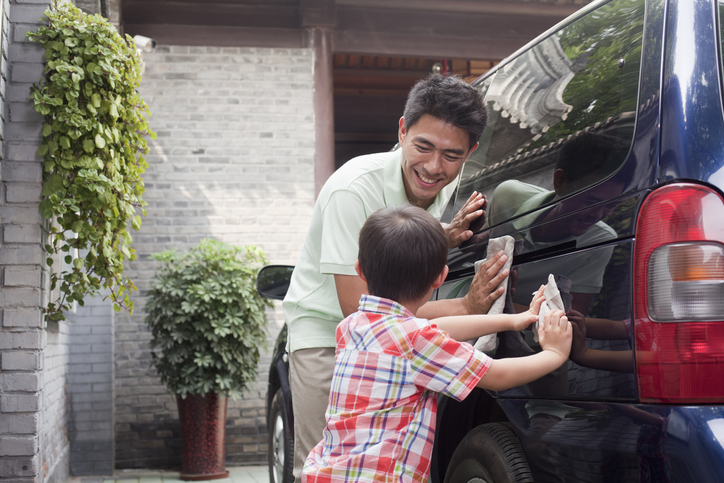 Happy father & son washing a minivan together, How to use the ‘first car’ as a great financial lesson with your kids….