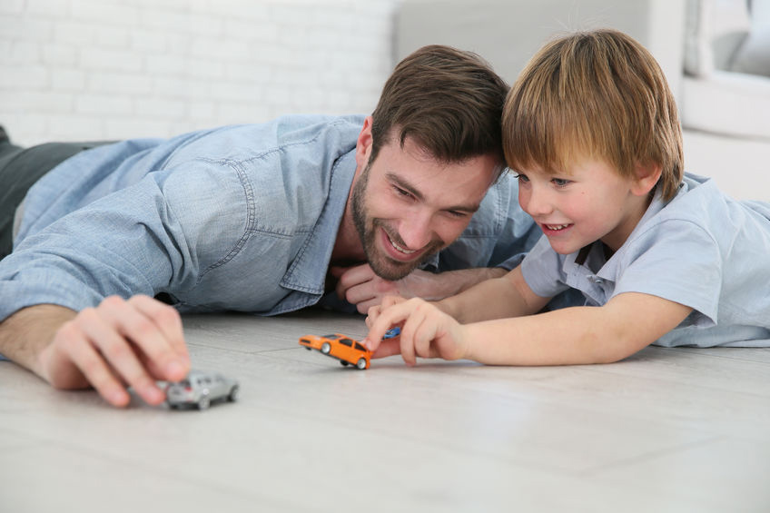 Daddy with little boy playing with toy cars