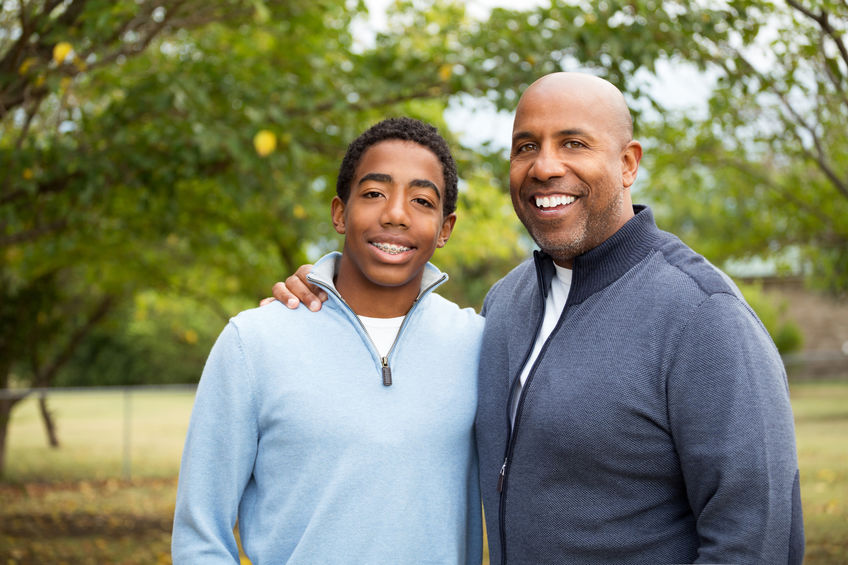 Smiling Father talking and spending time with his son
