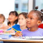 Happy children in a multi ethnic elementary classroom