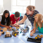 Students In After School Computer Coding Class Building And Learning To Program Robot Vehicle