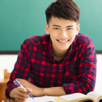 Smiling college student in university classroom