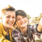Happy girlfriends in love sharing time together at travel trip p
