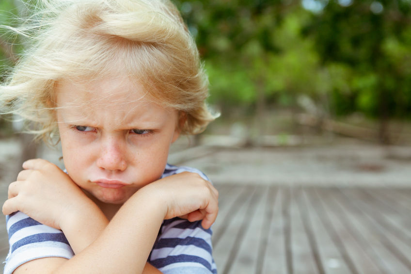 Face portrait of annoyed, unhappy caucasian kid with crossed arms