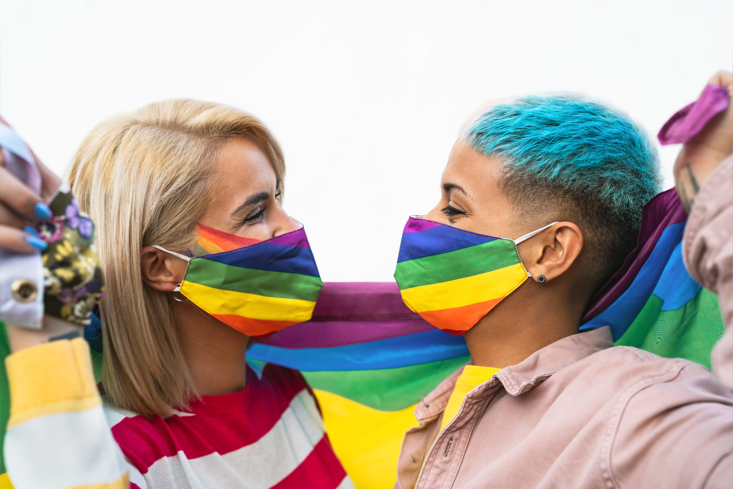 support LGBTQ+ kids as a parent – Happy gay couple wearing face mask celebrating gay pride event d