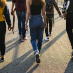 Teens walking backs to camera