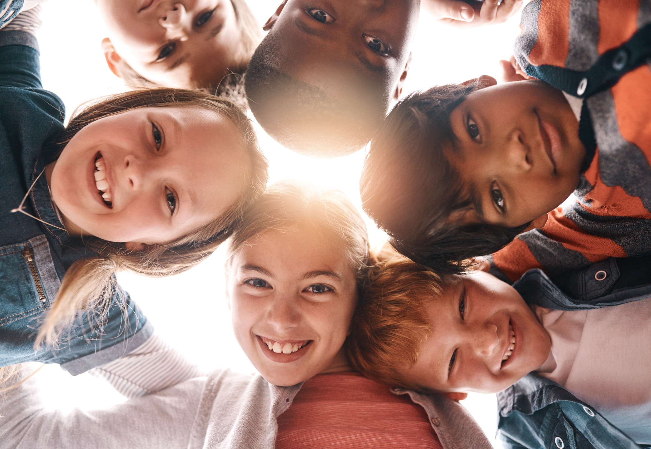 Park, happy and portrait of children in circle for friendship, community and playing together outdoors. Diversity, childhood and low angle of girls and boys for youth, child development and education how to raise independent kids