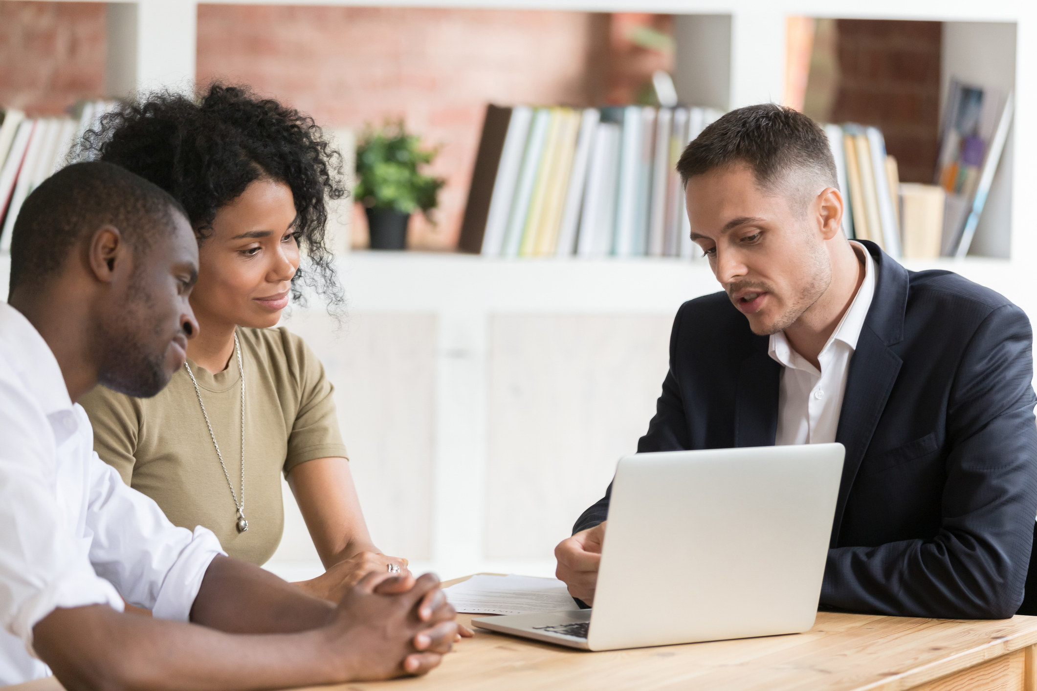 Navigating Your Child’s Special Education Process_MIT Exclusive,  Caucasian Real Estate Agent meeting with clients couple show houses at laptop