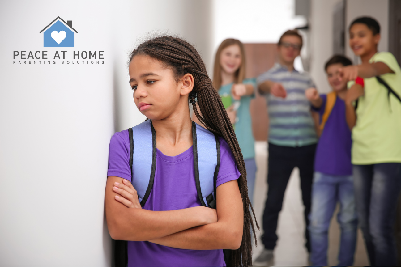 girl leaning on wall, looking sad, while peers bully her from behind, How to Recognize the Subtle Signs of Bullying — And What Parents Can Do About It,     national bullying prevention day – Peace at Home Parenting