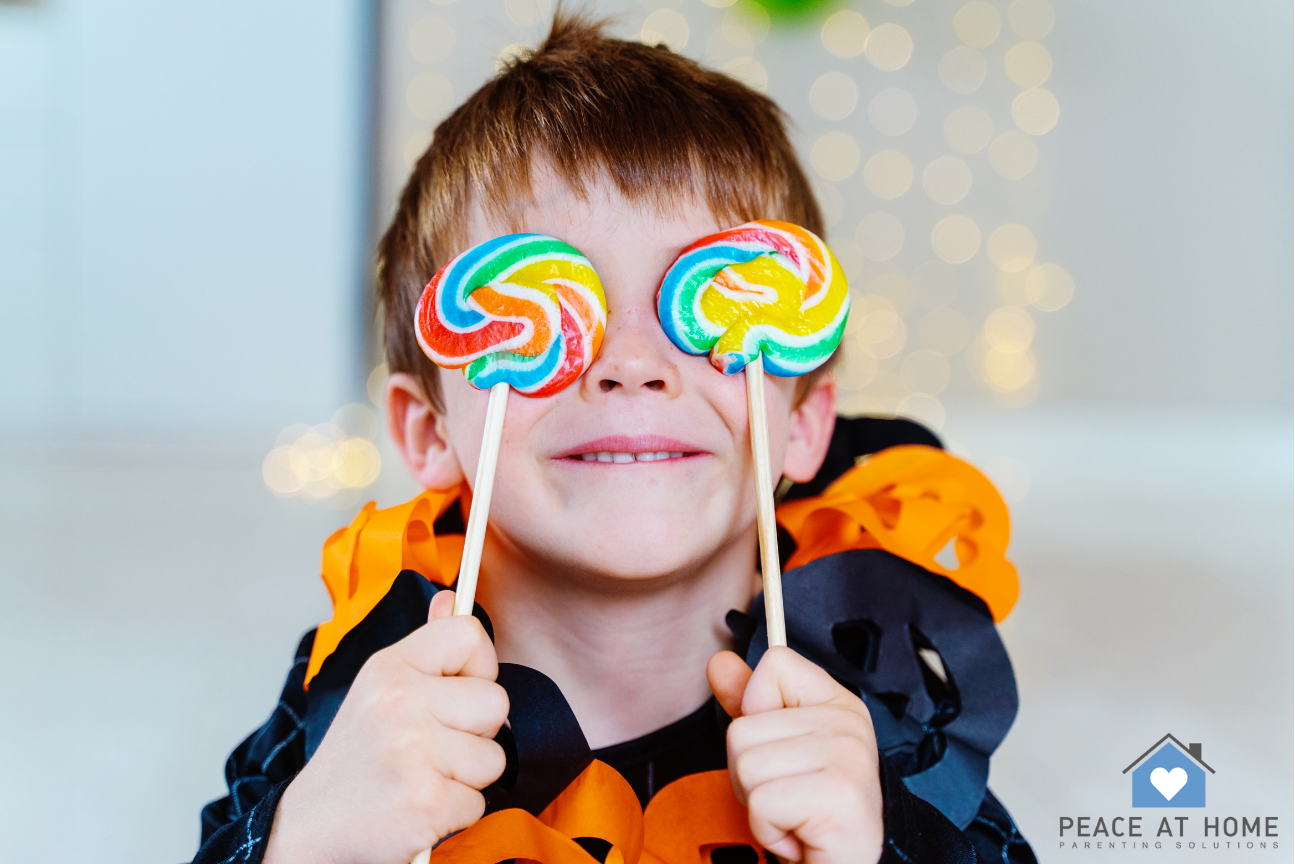child holding lollipops over his eyes and a halloween outfit on - peace at home parenting solutions,  child holding lollipops over his eyes and a halloween outfit on – peace at home parenting solutions