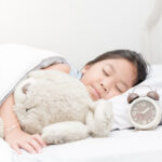 cute girl sleep and hug teddy bear.